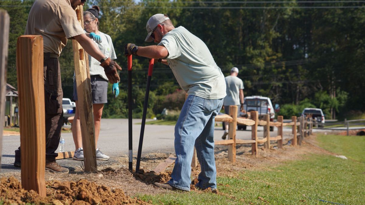 GreenPoint Team Members Building Wooden Fence